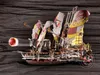 A toy vehicle with sails and a projectile being launched, set against a dark, textured background. Anteprima dell’immagine prodotto