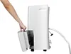 A hand is shown removing the water collection tank from a white dehumidifier. Náhled obrázku produktu