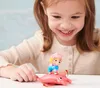 A young girl is playing with a Paw Patrol Aqua Pups action figure. Produktbild-Vorschau