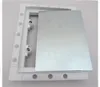 A white plastic frame with a silver metal plate inside, shown from a diagonal angle against a white background. Produktbild-Vorschau