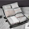 A set of packing cubes organized inside an open suitcase. Voir les images du produit