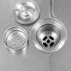 Close-up view of a stainless steel sink drain assembly with a strainer basket and a drain cover. Podgląd zdjęcia produktu