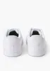 A pair of white Puma sneakers shown from the back. Podgląd zdjęcia produktu