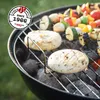 A charcoal grill with food cooking on it. Produktbild-Vorschau