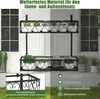 A black metal plant stand with potted plants is shown on a balcony or patio, with rain effects indicating outdoor use. Produktbild-Vorschau