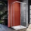 A modern bathroom with a red accent wall, featuring a glass shower enclosure. Náhľad obrázku produktu