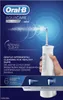 The image shows the packaging of an Oral-B AquaCare 6 Pro Expert water flosser, with a hand holding the product and water spraying from it. Náhľad obrázku produktu