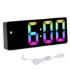 A digital alarm clock with a colorful display and its charging cable. Náhled obrázku produktu