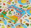 A game box and cards are spread out on a surface. Podgląd zdjęcia produktu