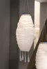 Two white paper lanterns hang indoors, one in the foreground and another partially visible in the background. Produktbild-Vorschau