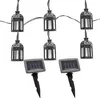 A string of solar-powered lantern-shaped LED lights with two solar panels on stakes. Produktbild-Vorschau