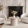 A living room scene with a fireplace, two armchairs, and a coffee table. Produktbild-Vorschau