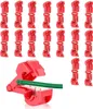A collection of red wire connectors and one connector with a green wire inserted. Produktbild-Vorschau