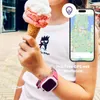 A child is holding an ice cream cone and wearing a smartwatch. A smartphone displaying a map is also visible. Produktbild-Vorschau