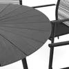 A close-up view of a round outdoor dining table and a chair. Produktbild-Vorschau