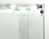 A close-up view of a glass display cabinet with a lock and key. Produktbild-Vorschau