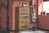 A hallway or entry area with a rustic-style shoe cabinet, coats hanging on hooks, and boots on the floor. Náhled obrázku produktu