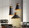 Three pendant lights hang above a black leather armchair in a well-lit room. Náhled obrázku produktu