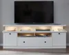 A white media console with a television on top, and various media devices and books on the shelves. Produktbild-Vorschau