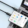 A black USB-C to USB-C cable connecting a smartphone to a laptop. Náhľad obrázku produktu