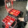 A person is shown organizing tools in a stackable tool organizer. Anteprima dell’immagine prodotto