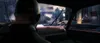 View from inside a car looking out at a post-apocalyptic city scene. Produktbild-Vorschau