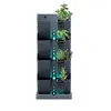 A vertical planter with multiple tiers, each holding a small plant. Water droplets are depicted flowing down the center. Náhled obrázku produktu