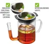 A glass jug with a metal strainer insert, containing liquid and vegetables, with text overlays highlighting features. Náhľad obrázku produktu