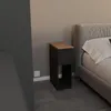 A narrow black bedside table with a wooden top is placed next to a bed. Podgląd zdjęcia produktu