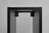 A close-up view of the top of a black metal shelf unit, showing the mounting brackets. Náhľad obrázku produktu