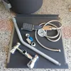 A collection of plumbing fixtures and accessories laid out on a dark surface. Produktbild-Vorschau