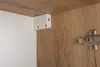 Close-up view of cabinet interior with wooden finish and white mounting bracket. Náhľad obrázku produktu