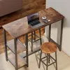 A bar table set with a laptop, coffee cup, and phone on it, placed in a room with wooden floors and a couch. Podgląd zdjęcia produktu