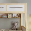 A close-up view of a bunk bed's upper section, showing shelves with books and decorative items, and a stuffed elephant below. Anteprima dell’immagine prodotto