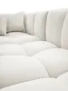 A close-up view of a white sectional sofa with plush cushions and a textured fabric. Náhled obrázku produktu