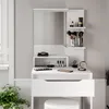 A white vanity table with a mirror and various makeup items on it. Podgląd zdjęcia produktu