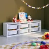 A children's storage unit with toys and decorations in a room. Produktbild-Vorschau