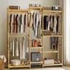 A bamboo wardrobe stand with clothes hanging on it and storage boxes on shelves. Náhled obrázku produktu