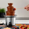 A chocolate fountain with strawberries and marshmallows on a countertop. Podgląd zdjęcia produktu
