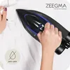 A person is ironing a white shirt with a black and blue iron. Produktbild-Vorschau