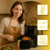 A woman is smiling in a kitchen next to a black and gold air fryer with a chicken inside. There are icons representing temperature, settings, and heat. Produktbild-Vorschau