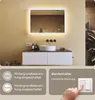 A bathroom vanity with a lit mirror, sink, and cabinet, along with informational overlays about lighting controls and a wall switch. Produktbild-Vorschau