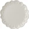 A white ceramic plate with embossed festive designs around the rim. Produktbild-Vorschau