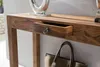 A close-up of a wooden console table with an open drawer, a decorative object on top, and a bag underneath. Produktbild-Vorschau