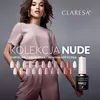 A woman is posing in front of a display of nail polish colors, with a bottle of nail polish prominently featured. Anteprima dell’immagine prodotto