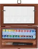 An open wooden box containing watercolor paints and brushes. Produktbild-Vorschau