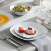 A beautifully set table with a multi-course meal, featuring soup, salad, and dessert. Produktbild-Vorschau