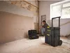 A man is working on a construction site with tools. Voir les images du produit