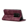 A burgundy flip case for a smartphone is shown from the side, with the phone partially inserted. Produktbild-Vorschau