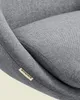 Close-up of a grey fabric chair with a sewn-on brand tag. Náhled obrázku produktu
